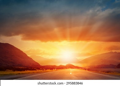 Picturesque Landscape Scene And Sunrise Above Road