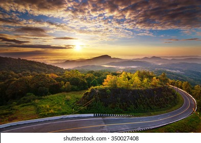 Picturesque Landscape Scene And Sunrise Above Road