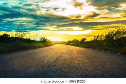 Picturesque Landscape Scene And Sunrise Above Road