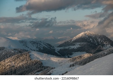 Picturesque Landscape Scene View Of Sky And Grey Clouds And Winter Mountain Landscape With Snow Covered Evergreen Trees