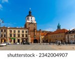 Picturesque Lublin cityscape with historic symbol of city - medieval brick gate Brama Krakowska in sunny spring day, Poland