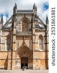 Picturesque main portal of medieval Santa Maria da Vitoria monastery church in Batalha, a manueline gothic masterpiece, Portugal