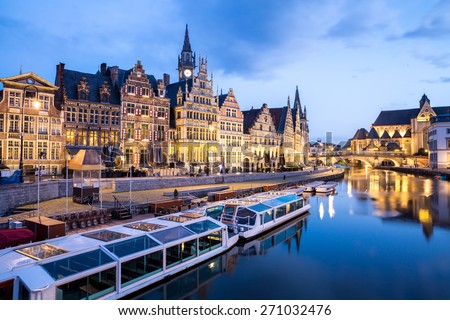 Picturesque medieval buildings on Leie river in Ghent town, Belgium at dusk.