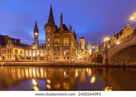 Picturesque medieval buildings on quay Graslei and Leie river at night, Ghent, Belgium