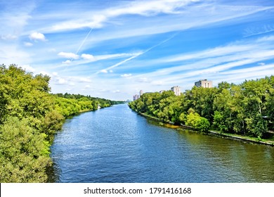 picturesque moscow city moskva river canal nature landmark with forest park scenery reflection on water against blue sky background. Urban landscape. Summer in city. Wide view