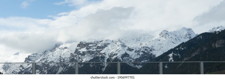 Picturesque Mountain Landscape In South Tirol In Autumn, View From The Highway To The Snow-covered Mountains, Blue Sky With Clouds, No People