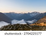 Picturesque mountain range with clouds rolling over mountain tops. Glacier National Park, BC