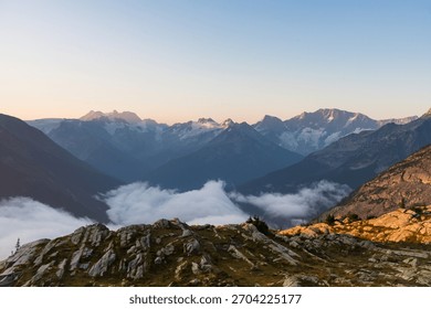 Picturesque mountain range with clouds rolling over mountain tops. Glacier National Park, BC