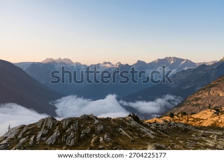 Picturesque mountain range with clouds rolling over mountain tops. Glacier National Park, BC