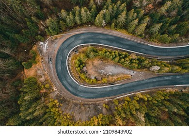 Picturesque mountains and serpentine roads, forest and road, steep turns of roads, road in the mountains, road view from above.