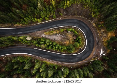 Picturesque mountains and serpentine roads, forest and road, steep turns of roads, road in the mountains, road view from above.