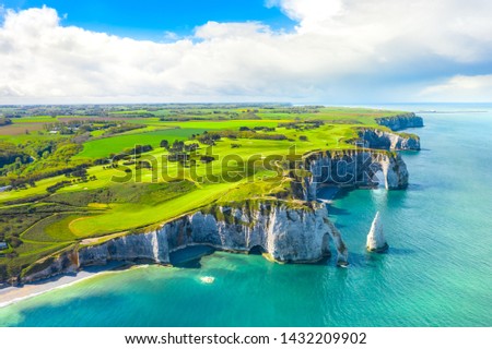 Picturesque panoramic landscape on the cliffs of Etretat. Natural amazing cliffs. Etretat, Normandy, France, La Manche or English Channel. Coast of the Pays de Caux area in sunny summer day. France
