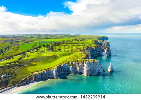 Picturesque panoramic landscape on the cliffs of Etretat. Natural amazing cliffs. Etretat, Normandy, France, La Manche or English Channel. Coast of the Pays de Caux area in sunny summer day. France
