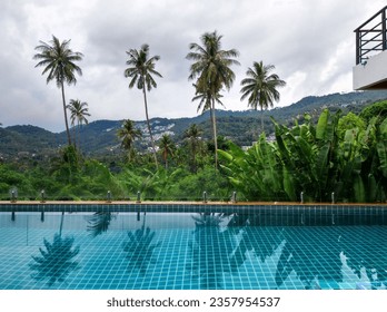 Picturesque pool in a cottage on a mountainside with a beautiful view of the mountainous tropical area - Powered by Shutterstock