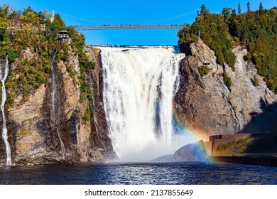 Picturesque rainbow glitters in water splashes. The powerful waterfall of Montmorency. Travel to Canada. Surroundings of the ancient picturesque city of Quebec. 