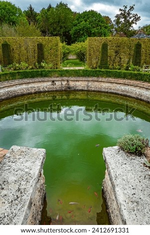  Picturesque round pool in the park greenhouse. The“possession of Puss in Boots”. Graceful bosquets surround the pool in Breteuil Park. Castle of Breteuil. France