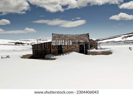 A picturesque scene captured in Bodie, California, showcasing a lone shack amidst a winter wonderland.