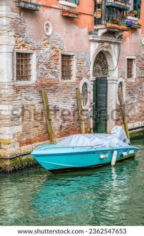 Picturesque scene from Venice with a boat docked or moored on the narrow water canals.
