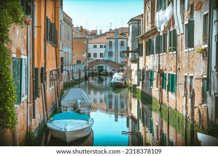 Picturesque Scene from Venice with  many boats parked on the narrow water canals.