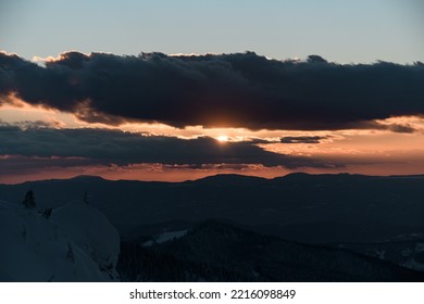 Picturesque Scene View Of Morning Sun And Sky With Grey Clouds And Winter Mountain Landscape With Evergreen Trees