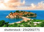 picturesque seascape of beautiful isle Sveti Stefan near Budva Montenegro. Scenic orange buildings in Ardiatic sea with blue water and amazing sky on background of landscape