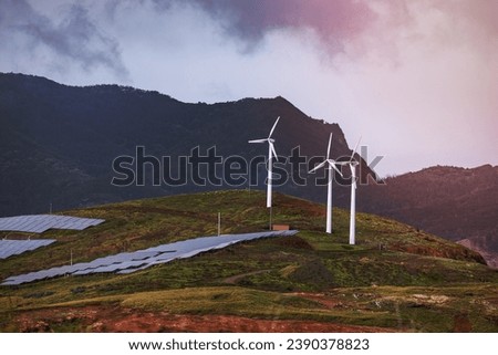 A picturesque sky filled with clouds embracing a wind farm of majestic turbines, powering our world in an environmentally-friendly manner. Madeira, Portugal