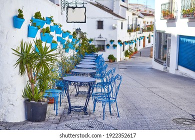Picturesque street of Mijas with flower pots on facades. Andalusian white town. Cost of the Sun. Southern Spain