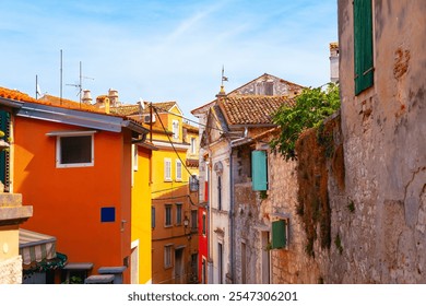 Picturesque street scene in a European town, characterized by colorful buildings. The architecture includes tiled roofs, shuttered windows giving it a charming and historic feel - Powered by Shutterstock