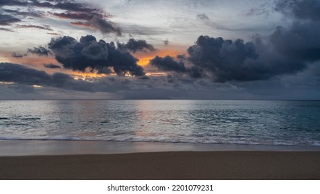 Picturesque sunset over the Indian Ocean. Blue clouds in the sky, highlighted in orange. Reflection on calm water. Foam of waves on the sand of the beach. Seychelles. Mahe. Beau Vallon - Shutterstock ID 2201079231
