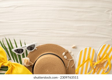 A picturesque top view scene of summer sunbathing. Beach essentials—glasses, headwear, shells, bracelet, flip-flops, swimsuit, palm leaf—set against sandy shoreline. Empty space invites text or promo - Powered by Shutterstock