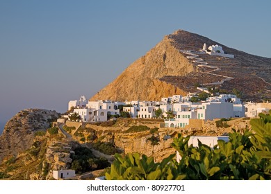 The picturesque town of Chora on Folegandros island, Greece, at sunset; the church of Virgin Mary sits on top of it