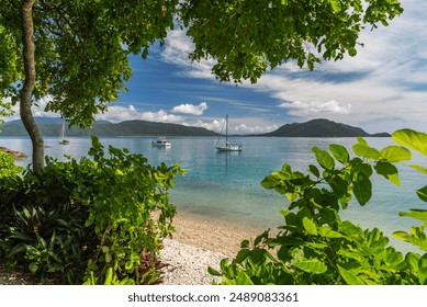 Picturesque tropical coral beach with turquoise water on Fitzroy Island. It is a continental island southeast of Cairns, Queensland, Australia. - Powered by Shutterstock