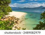 Picturesque tropical golden Nudey Beach with turquoise water on Fitzroy Island. It is a continental island southeast of Cairns, Queensland, Australia.