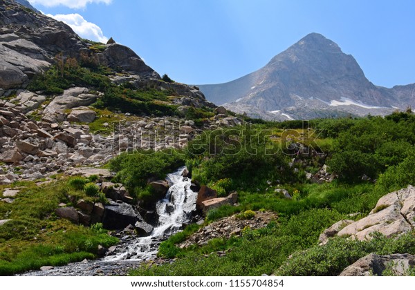 a picturesque  valley , creek, and mount toll on\
the hike to blue lake in summer in the indian peaks wilderness\
area, near nederland,\
colorado