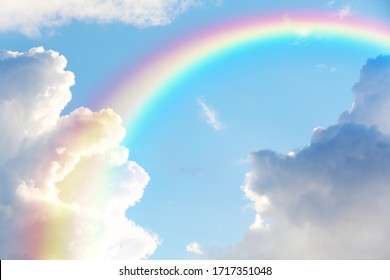 Picturesque view of beautiful rainbow and blue sky on sunny day 