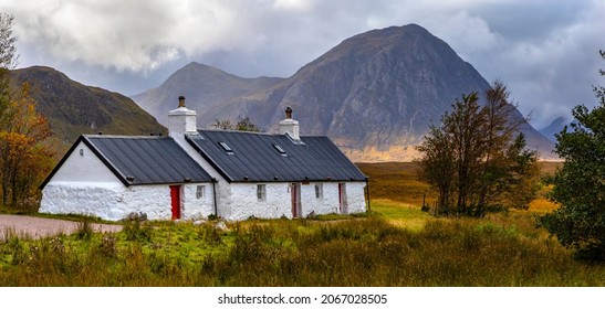 The picturesque view of Blackrock Cottage with Buachaille Etive Mor in the background, in the Glen Etive area of Glencoe in the Scottish Highlands.