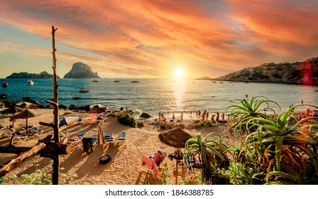 Picturesque View Of Cala D'Hort Tropical Beach, People Hangout In Beautiful Beach With Es Vedra Rock View During Magnificent Vibrant Sunset Glowing Sun. Balearic Islands, Spain, Espana. Ibiza