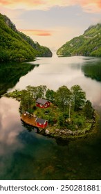 Picturesque view of a charming red cabin located on a small, serene island amidst the breathtaking fjords of Norway, perfectly showcasing the tranquility and beauty of nature, Lovrafjorden