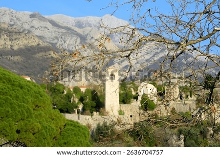 Picturesque view of Clock Tower in Old Town Bar (Stari Grad Bar) on the background of majestic Balkans mountains. Tourism and sightseeing of Montenegro