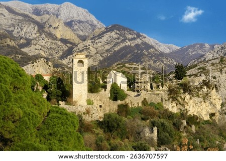 Picturesque view of Clock Tower in Old Town Bar (Stari Grad Bar) on the background of majestic Balkans mountains. Tourism and sightseeing of Montenegro