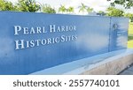 A picturesque view in front of the Pearl Harbor historical sites, featuring a serene landscape that combines history and natural beauty.