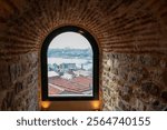 Picturesque view of Istanbul through arched window frame from iconic Galata Tower, Turkey. City