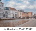 A picturesque view of the Leie River in Ghent, Belgium, near Saint Michael