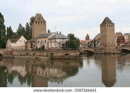 A picturesque view of the medieval Covered Bridges Ponts Couverts in Strasbourg, France, with their iconic towers and charming architecture.