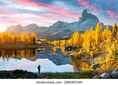 Picturesque view on Federa Lake in sunrise time. Autumn mountains landscape with Lago di Federa and bright orange larches in the Dolomite Apls, Cortina D'Ampezzo, South Tyrol, Dolomites, Italy