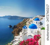 A picturesque view of Santorini, Greece, with its iconic white buildings and blue domes overlooking the sea.