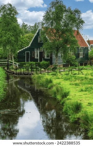 Picturesque view of traditional Houses by the Canal in the Historic Village of Zaanse Schans on the Zaan River in the Netherlands