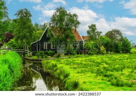 Picturesque view of traditional Houses by the Canal in the Historic Village of Zaanse Schans on the Zaan River in the Netherlands