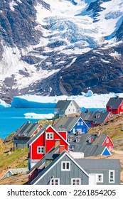 Picturesque village on coast of Greenland a giant iceberg in the background - Colorful houses in Tasiilaq, East Greenland - Shutterstock ID 2261854205