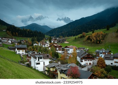 Picturesque village of Val di Funes with the dolomite rocky mountains in Italy at night.